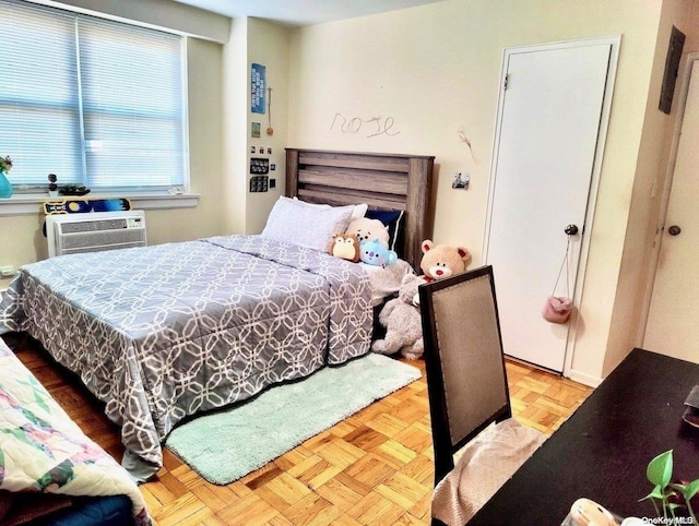 bedroom featuring light parquet flooring and a wall mounted AC