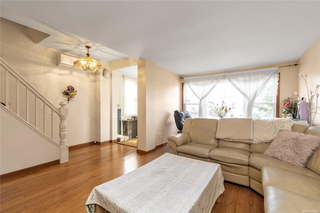 living room featuring hardwood / wood-style floors and a notable chandelier