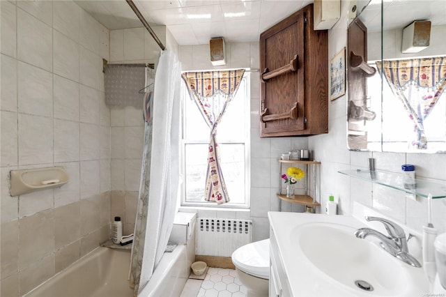 full bathroom with sink, tile patterned flooring, toilet, tile walls, and radiator heating unit