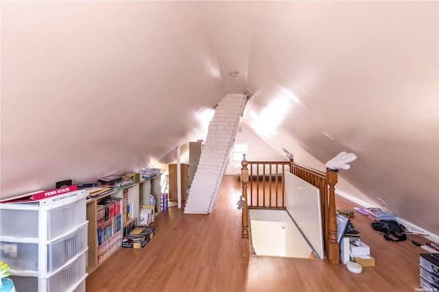 additional living space with lofted ceiling and wood-type flooring