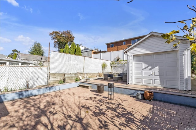 view of patio featuring an outbuilding and a garage