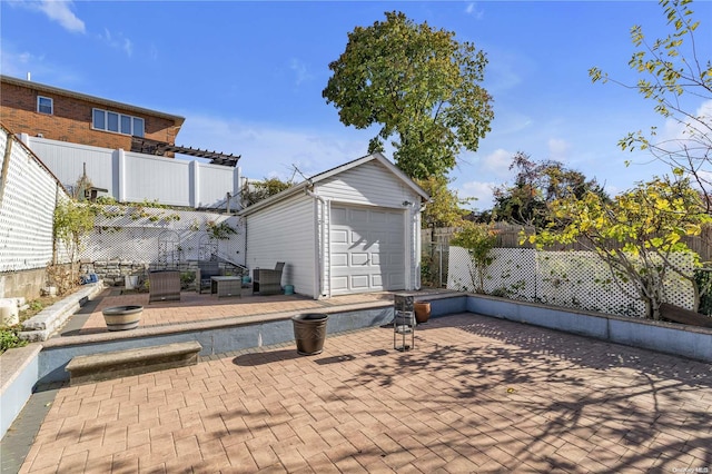 view of patio / terrace featuring a garage and an outdoor structure