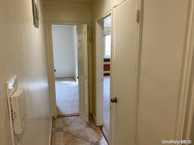 hallway featuring light tile patterned floors