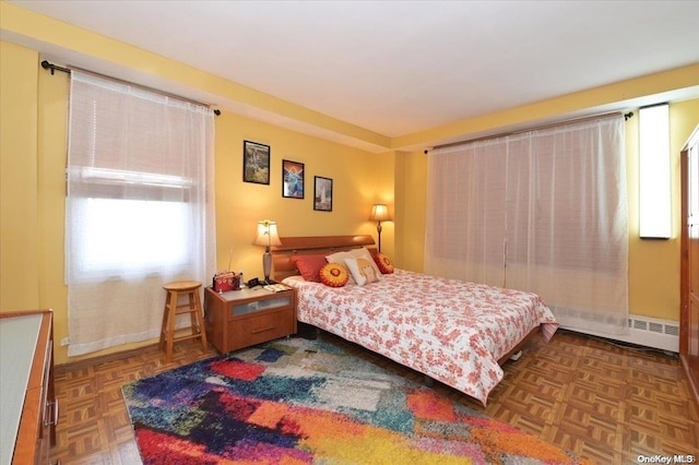 bedroom featuring dark parquet flooring