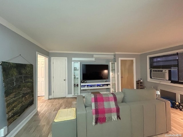 living room featuring crown molding, cooling unit, and light hardwood / wood-style floors