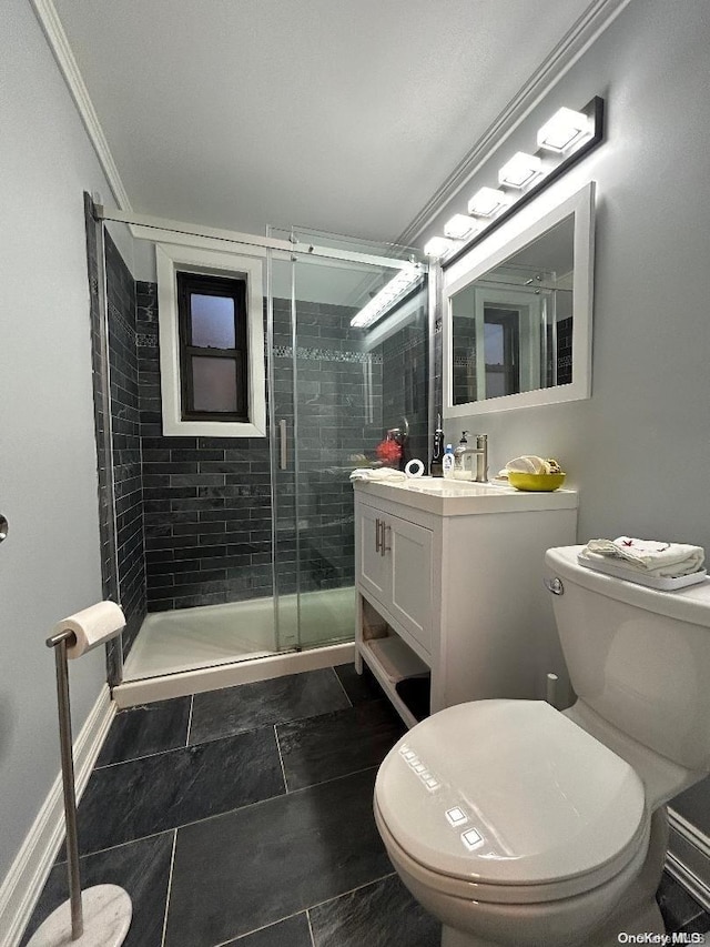 bathroom with tile patterned floors, crown molding, toilet, a shower with door, and vanity