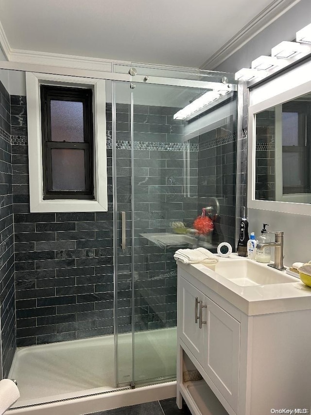 bathroom with vanity, an enclosed shower, and ornamental molding