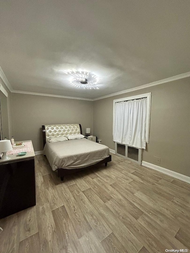 bedroom featuring hardwood / wood-style flooring and ornamental molding