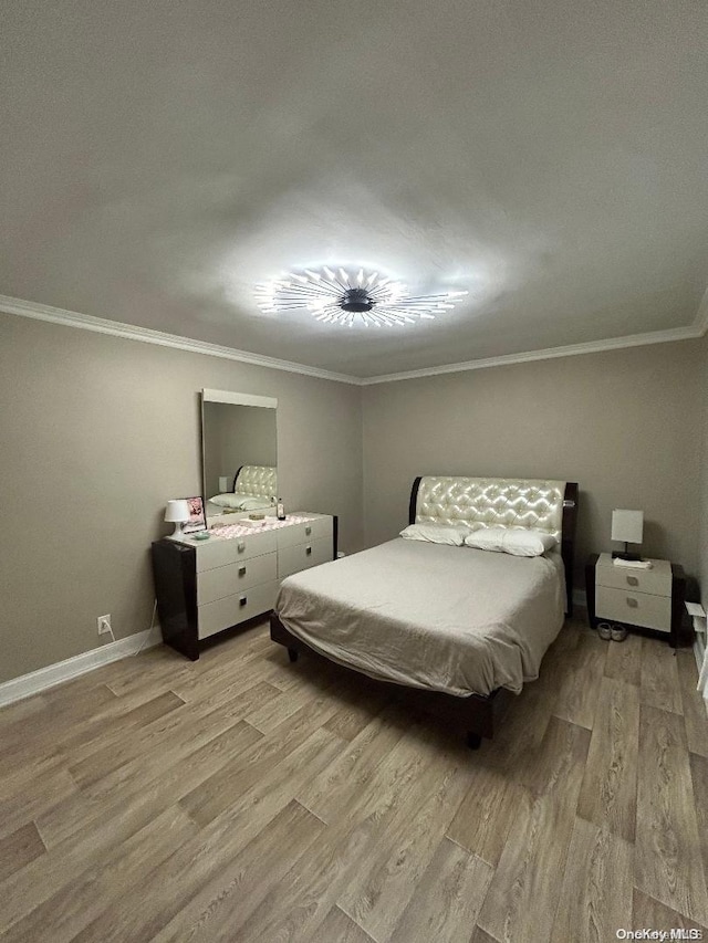 bedroom featuring light wood-type flooring and ornamental molding