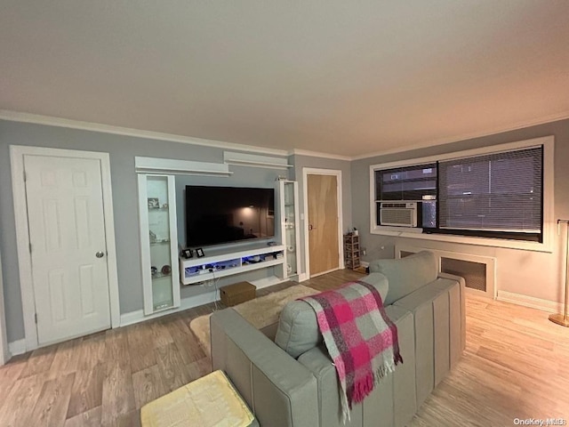 living room with cooling unit, crown molding, and light hardwood / wood-style flooring