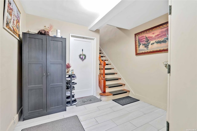 entryway with beamed ceiling