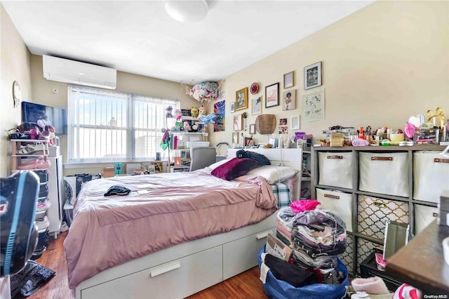 bedroom featuring a wall mounted AC and hardwood / wood-style flooring