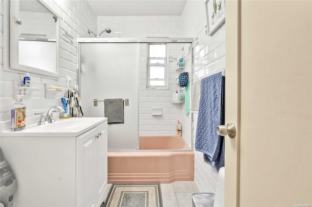 bathroom with vanity, tiled shower / bath combo, and tile patterned floors