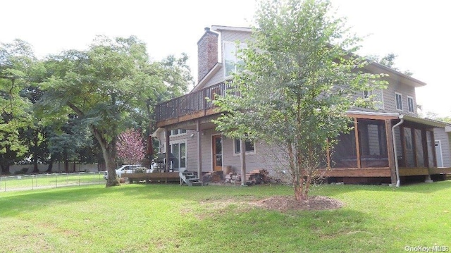 exterior space featuring a balcony and a yard