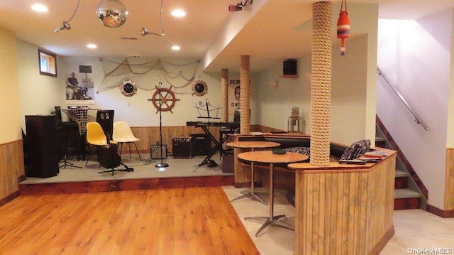 interior space featuring hardwood / wood-style flooring and wood walls