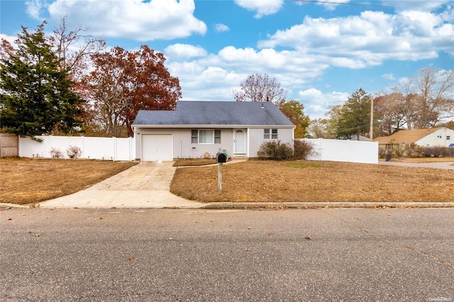 view of front facade with a front yard and a garage