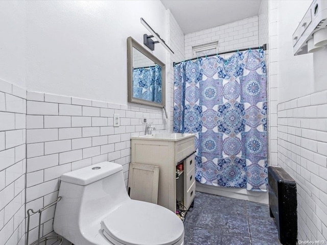 bathroom featuring walk in shower, vanity, tile walls, tile patterned flooring, and toilet