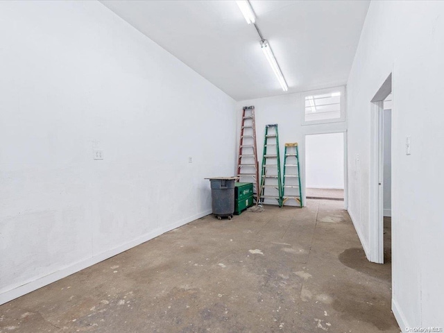 unfurnished room with concrete flooring