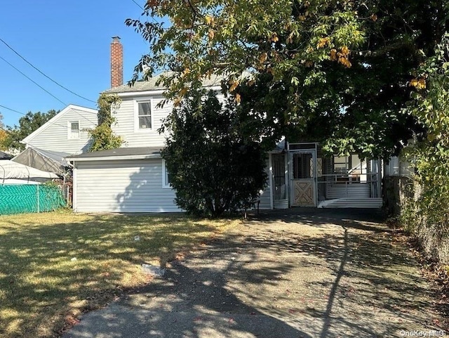 rear view of property with a yard