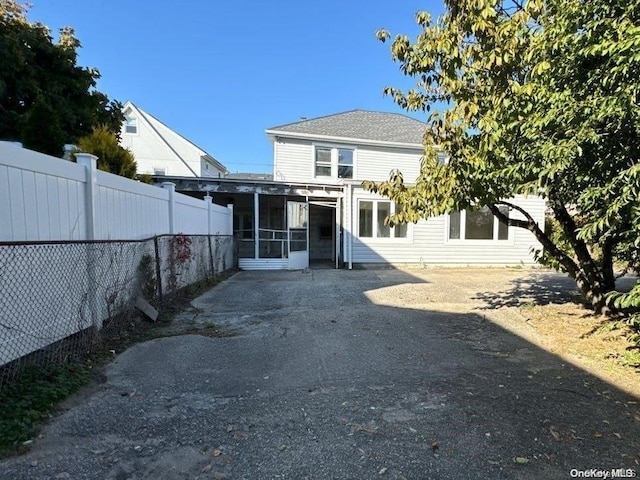 back of house featuring a sunroom