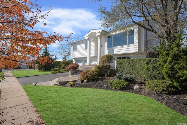 view of front of property with a garage and a front yard