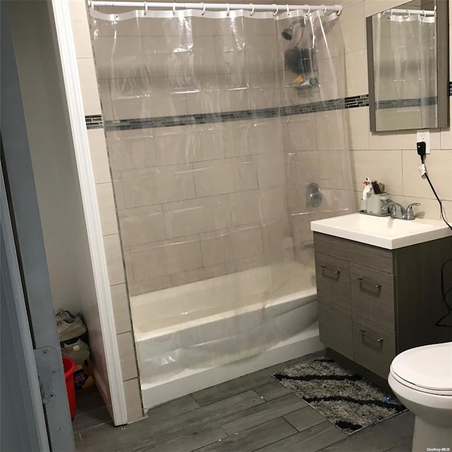 full bathroom with vanity, toilet, shower / bathtub combination with curtain, tile walls, and wood-type flooring