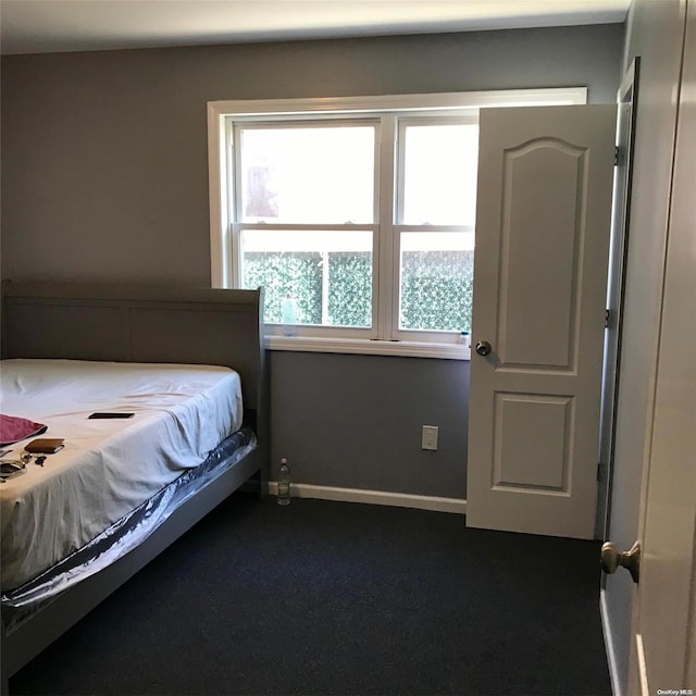 bedroom featuring dark colored carpet