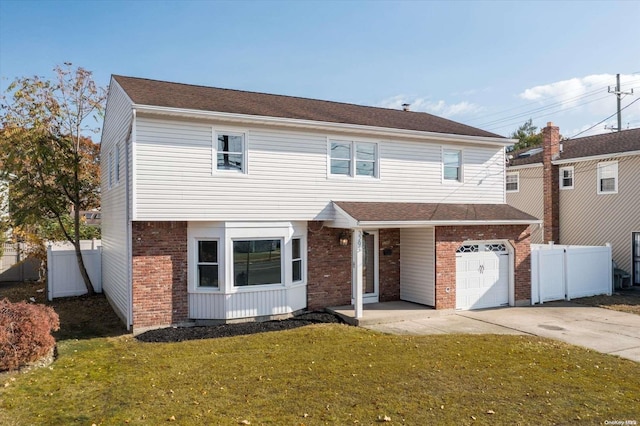 view of front of home with a garage and a front lawn