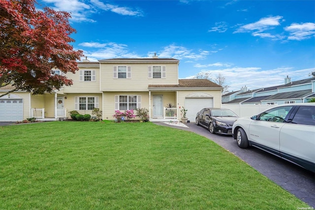 view of front of house featuring a front yard and a garage