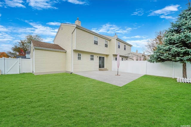 rear view of property with a yard and a patio