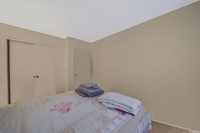 carpeted bedroom with a closet