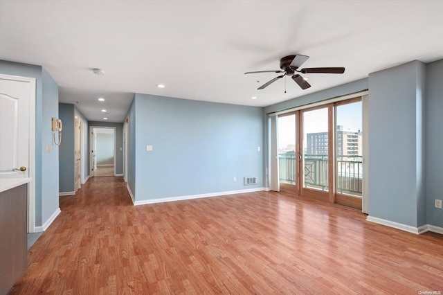 unfurnished room with ceiling fan and light hardwood / wood-style flooring