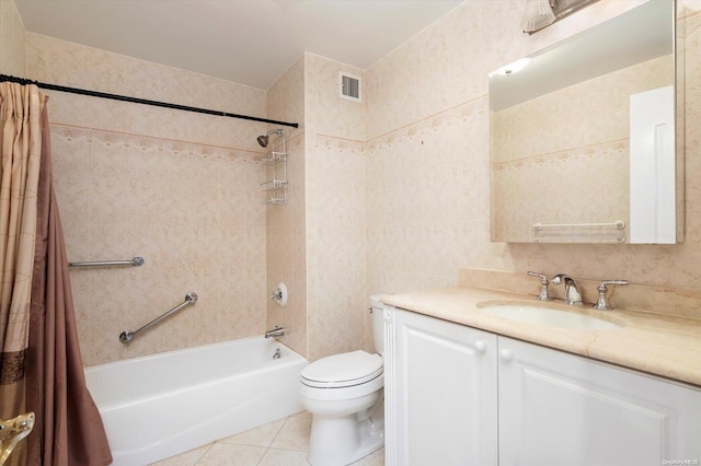 full bathroom with vanity, tile patterned floors, toilet, tile walls, and shower / tub combo