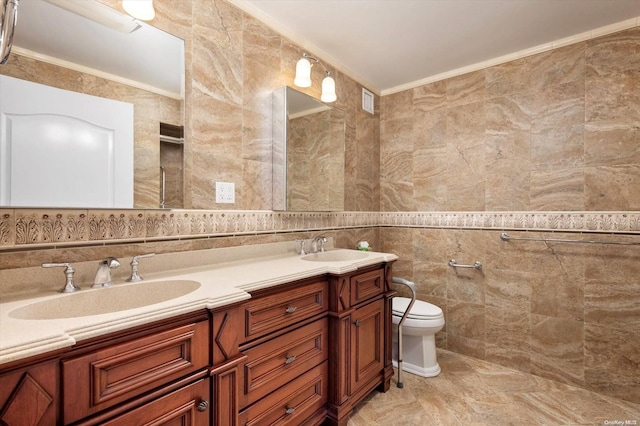 bathroom featuring crown molding, vanity, tile walls, and toilet