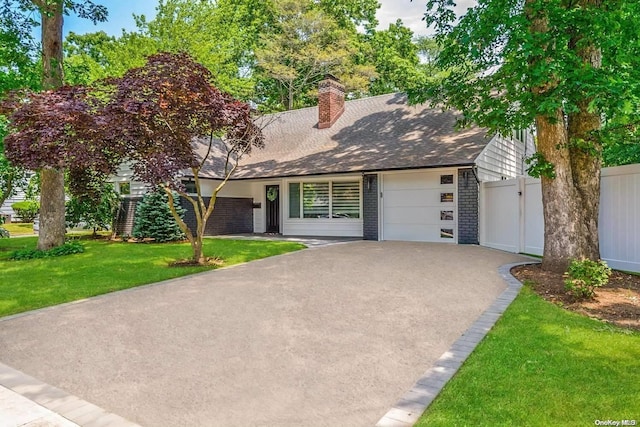 view of front of house with a garage and a front yard