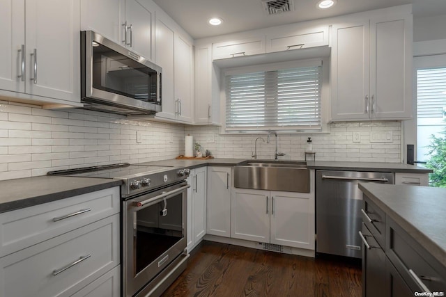 kitchen featuring dark wood-type flooring, sink, white cabinets, and stainless steel appliances