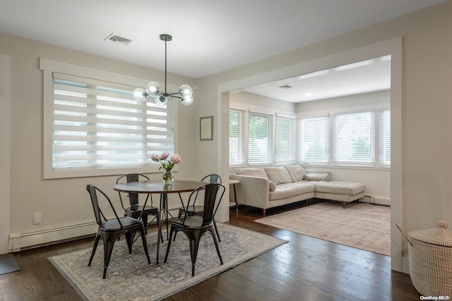 dining area with a chandelier, dark hardwood / wood-style flooring, and baseboard heating