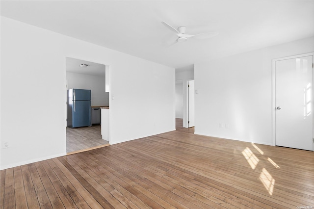 unfurnished room with ceiling fan and light wood-type flooring