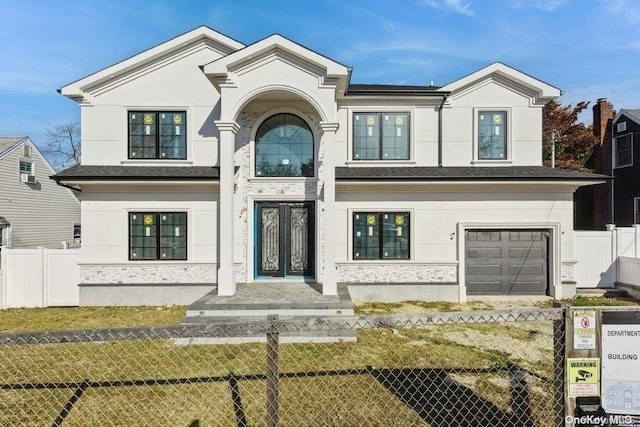 view of front of property with a front lawn and a garage