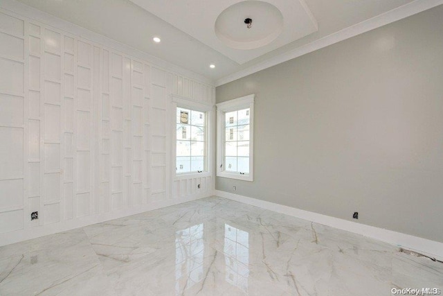 empty room featuring crown molding