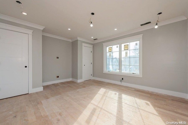 spare room with light hardwood / wood-style floors and ornamental molding