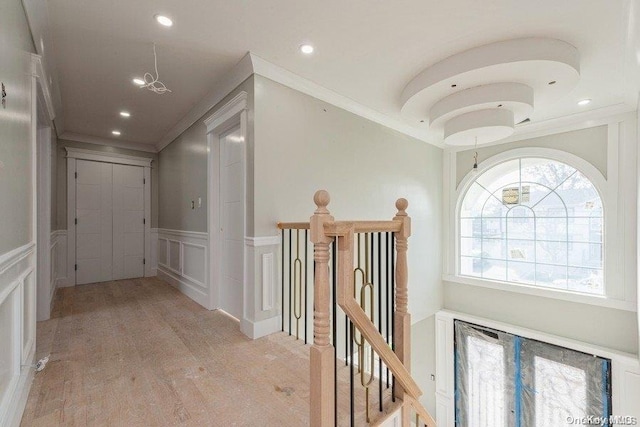 corridor with crown molding and light hardwood / wood-style flooring