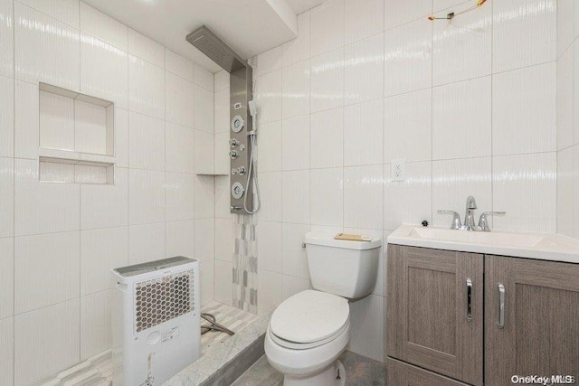 bathroom featuring heating unit, vanity, tile walls, and toilet