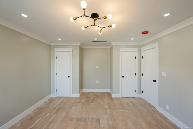 empty room with light hardwood / wood-style flooring and crown molding