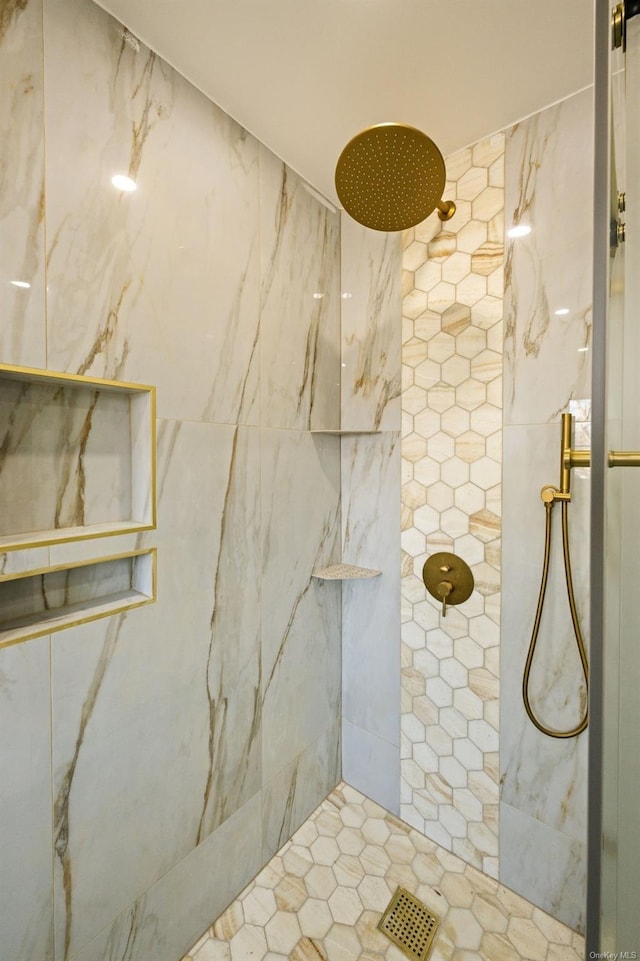 bathroom with tiled shower