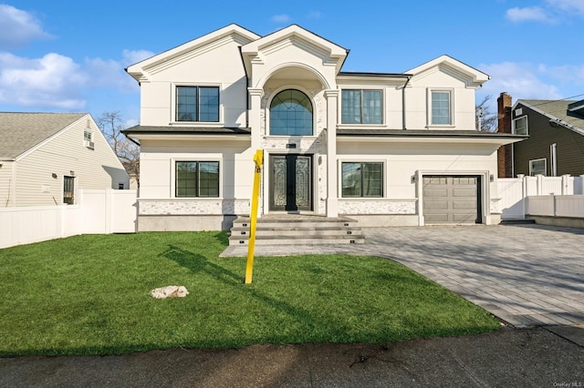 view of front of home with a front yard and a garage