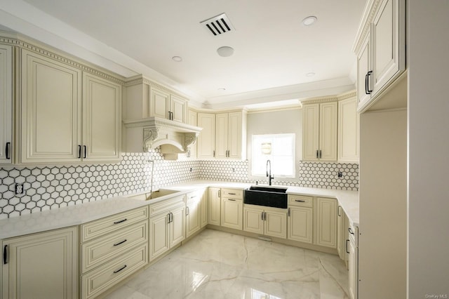 kitchen with cream cabinetry, sink, tasteful backsplash, black electric stovetop, and crown molding