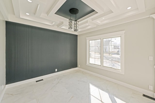 spare room with coffered ceiling and a notable chandelier