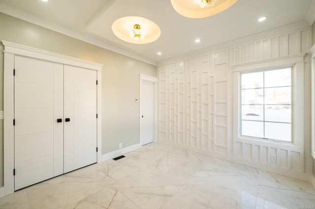 unfurnished bedroom featuring a closet and crown molding