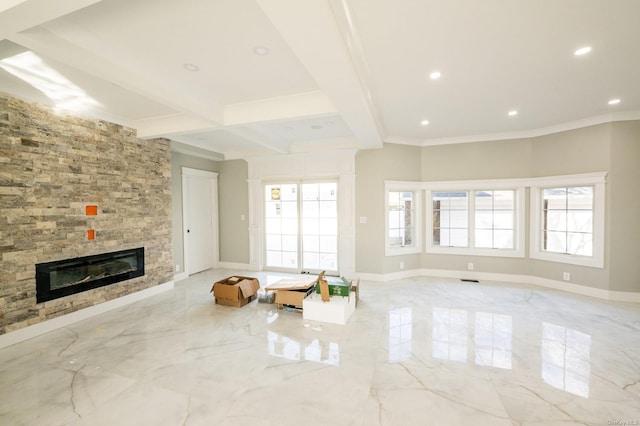 unfurnished living room featuring a healthy amount of sunlight, beam ceiling, crown molding, and a fireplace